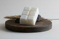 White wax melts on a wooden board with natural elements